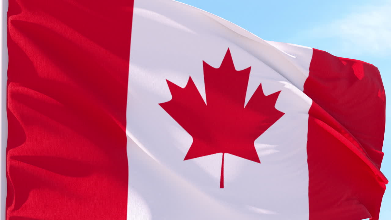 Canadian Flag Waving in Slow Motion Against Blue Sky