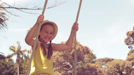 happy little girl on a swing in the park