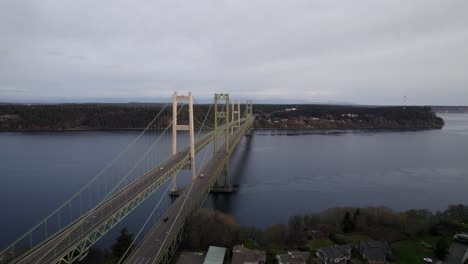 gloomy panorama over the tacoma narrows bridge and gig harbor washington, light traffic, aerial