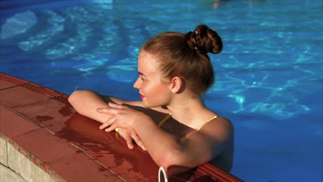 teenage girl relaxing by swimming pool