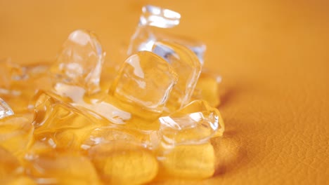 closeup of ice cubes on an orange background