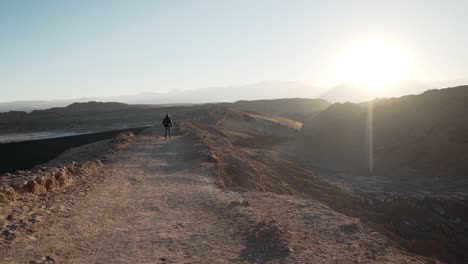 slow motion hiker walking on a mountain at sunrise in the desert