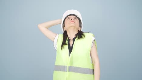 looking up, the engineer is holding her hard hat.