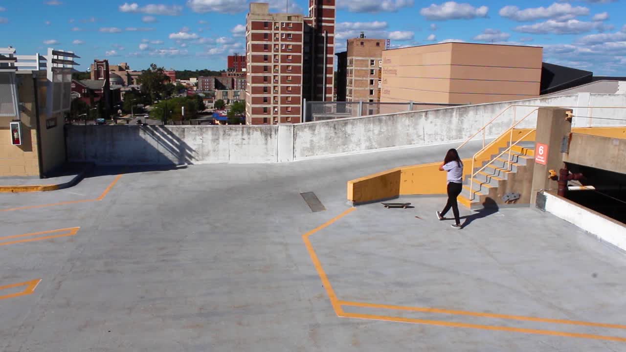 Girl trying to do tricks on a skateboard