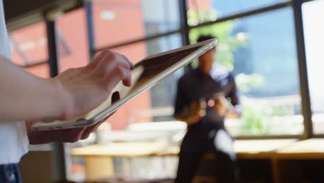 close-up of young businesswoman working on digital tablet in a modem office 4k