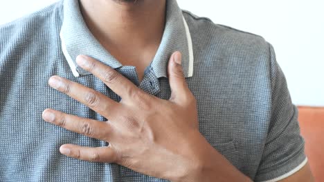 man with hand on chest