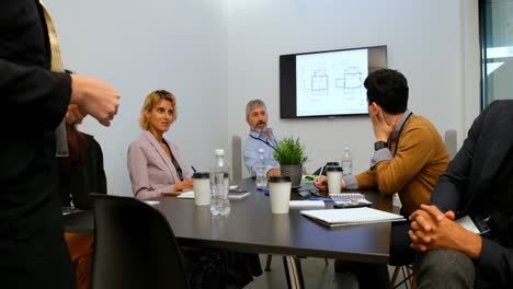 business colleagues interacting with each other in conference room 4k