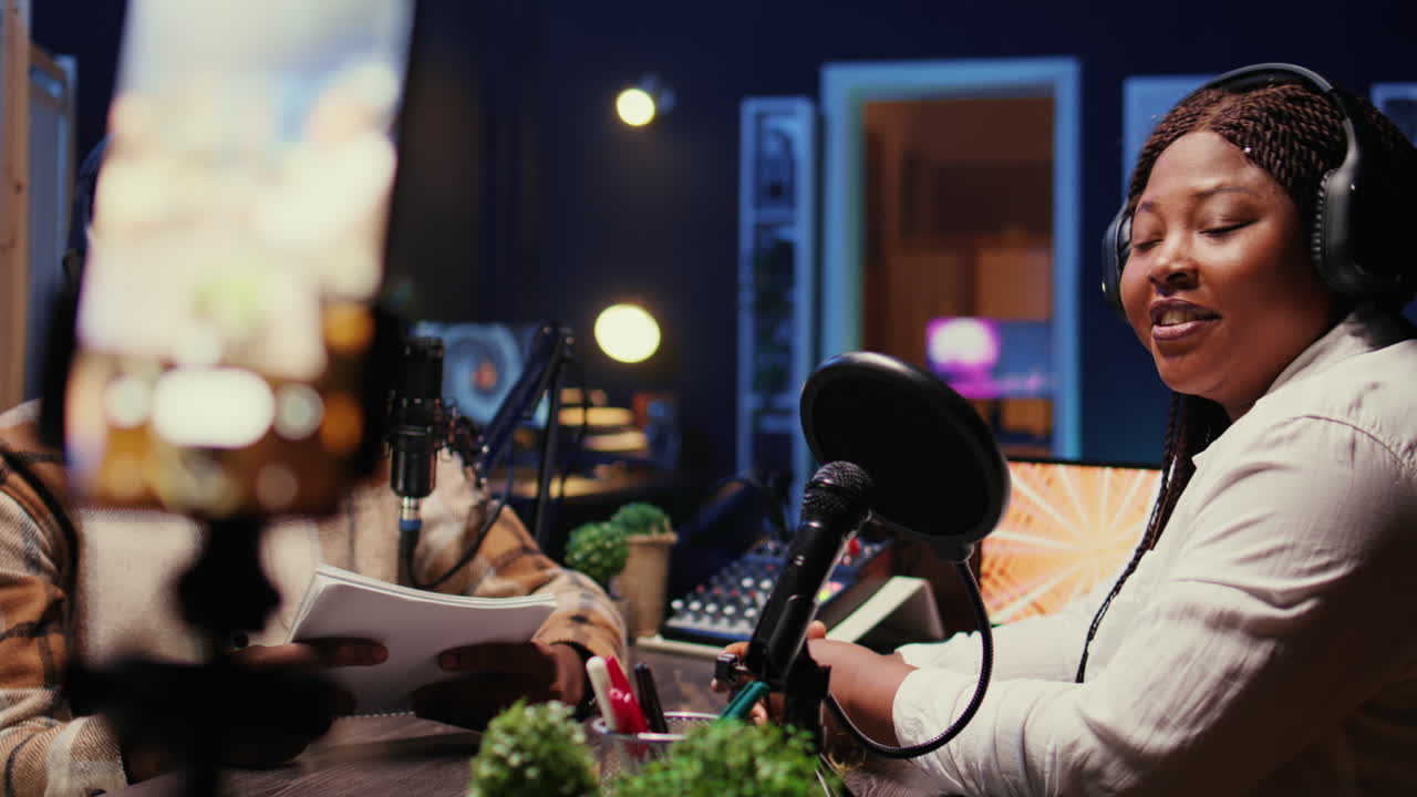 Woman laughing during comedy focused podcast filmed with cellphone on tripod stabilizer