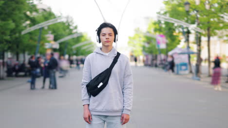 teenager with headphones and fanny pack