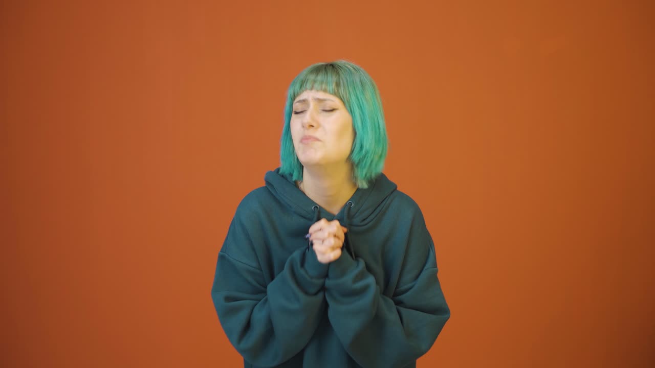 Young woman apologizing looking at camera.