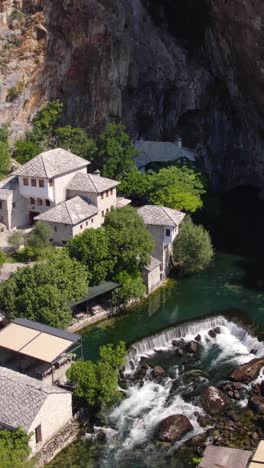 peaceful aerial view of blagaj tekija by the buna river in bosnia and herzegovina, vertical video