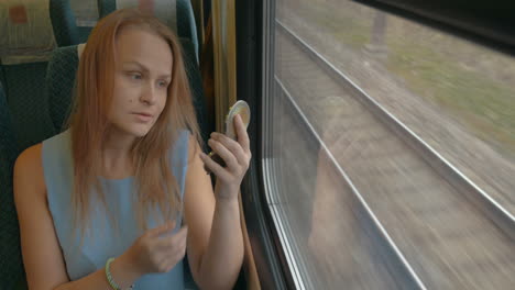 woman with pocket-glass in train