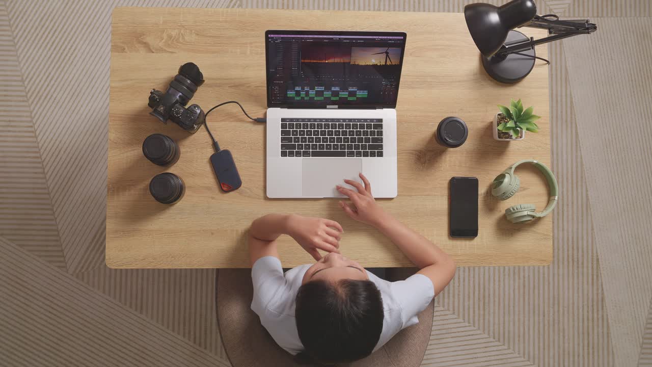 Person working on video editing on a laptop