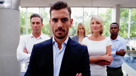 business executives with arms crossed at conference center