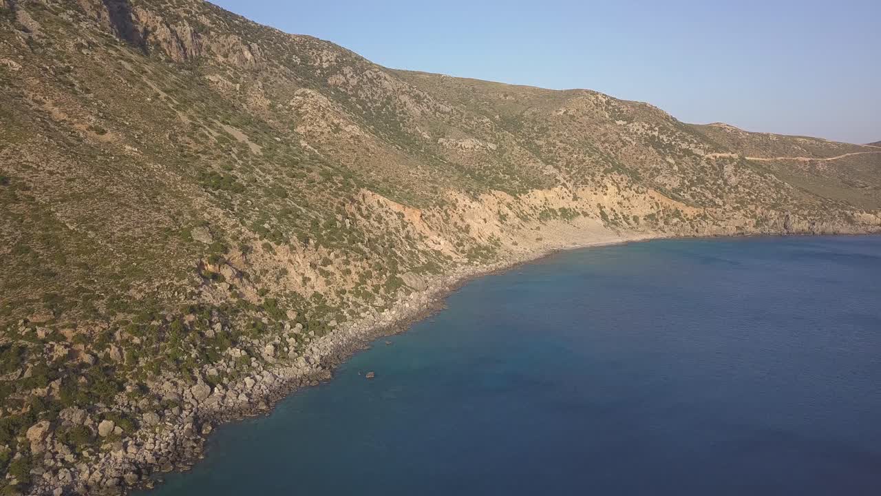 Aerial shot over Kedrodasos in Crete, Greece towards East and with an impressive view of the mountains on the left