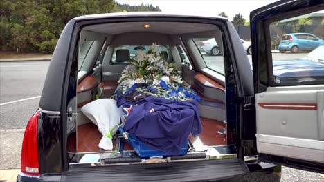 closeup shot of a funeral casket in a hearse or chapel or burial at cemetery