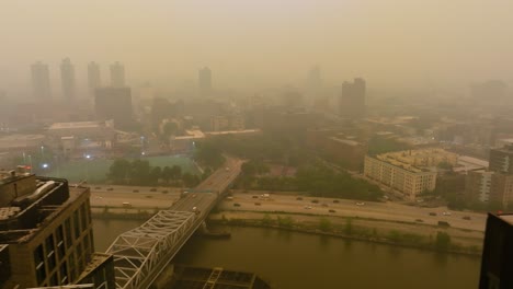aerial view overlooking traffic on the harlem river drive, smoke fog skies in new york, usa
