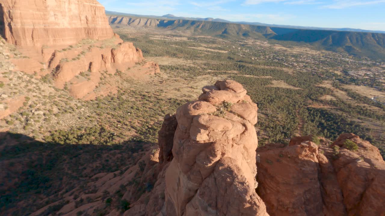 High angle circling view of Bell Rock butte, Arizona, on sunny day. Lens flare.