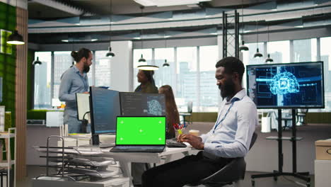 startup office programmer using green screen laptop, developing ai models