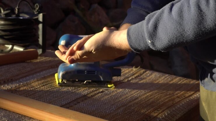 Caucasian male taking a short break during work and cleaning his hands off from dust