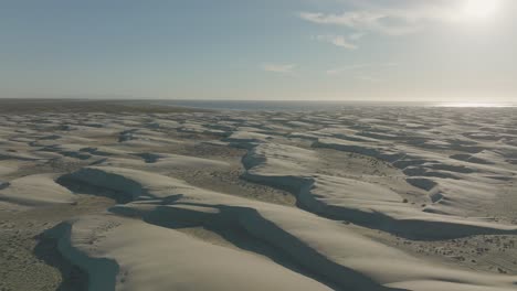 beautiful sand dune scenery of baja california sur shoreline, aerial flight with copy space in sky