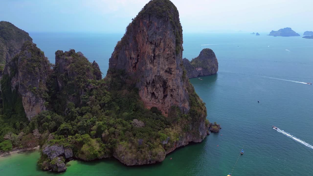 pensioner resting during a difficult Rock climb on Rai Leh beach cliff in Thailand. Unbelievable aerial view flight