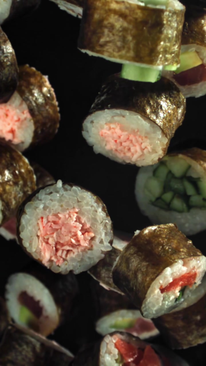 Sushi roll giapponesi assortiti che cadono al rallentatore