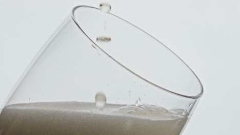 Beer-drops-falling-glass-closeup.-Alcoholic-liquid-blob-dripping-at-hoppy-lager