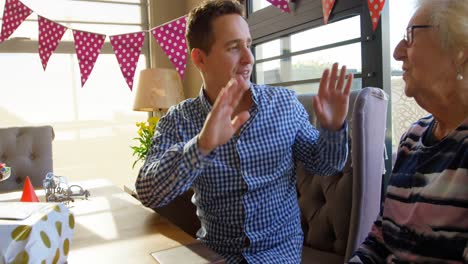 Mother-and-son-giving-high-five-to-each-other-at-home-4k