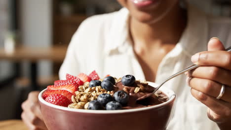Enjoying a Healthy Acai Bowl with Fresh Berries and Granola