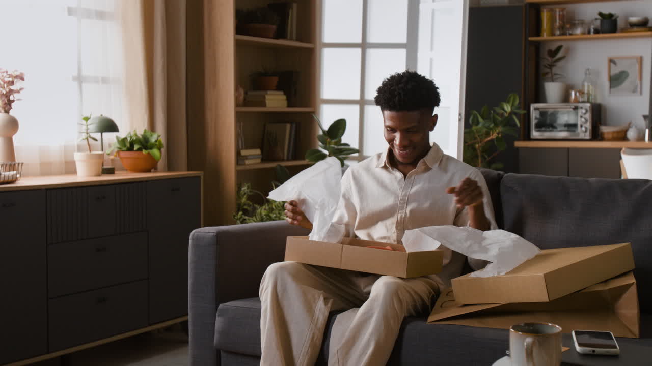 Man unpacking boxes in a living room