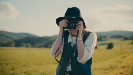 smiling woman capturing pictures through camera