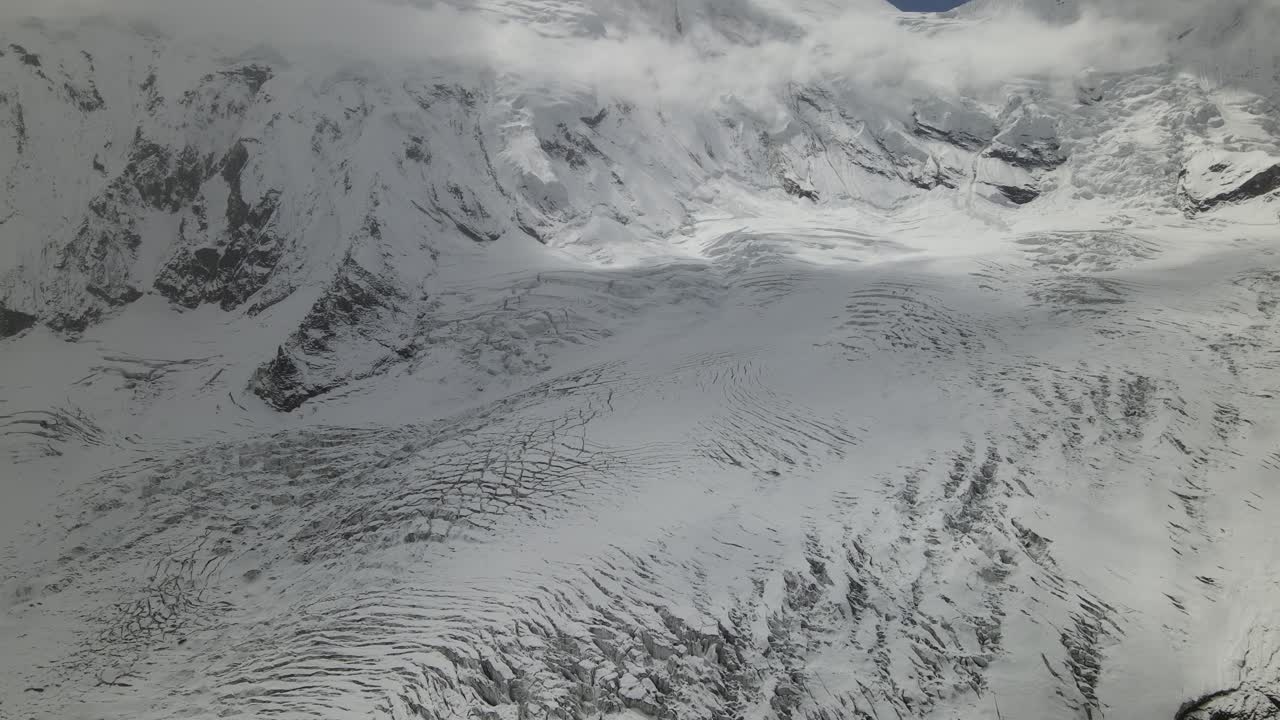 A breathtaking drone view of Manaslu Mountain, rising 8,163 meters in the Nepal Himalaya. The footage captures its towering peaks, dramatic ridges, and pristine high-altitude landscape