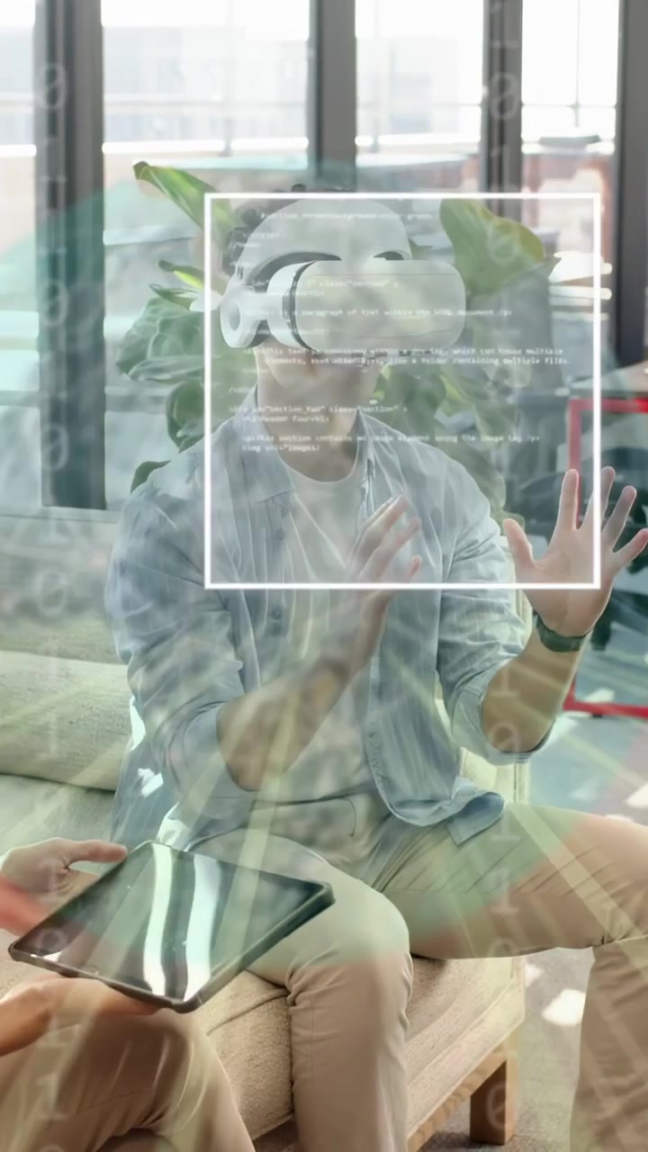 Vertical video: Man putting on VR headset in tech lounge team with tablet holograms guiding pinches