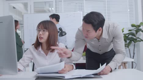 pan shot of female worker and male manager talking,discussing digital online project and marketing laugh having fun working together in corporate office.
