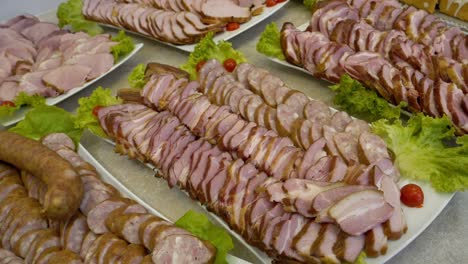 platter with slices of ham, bacon, and sausage