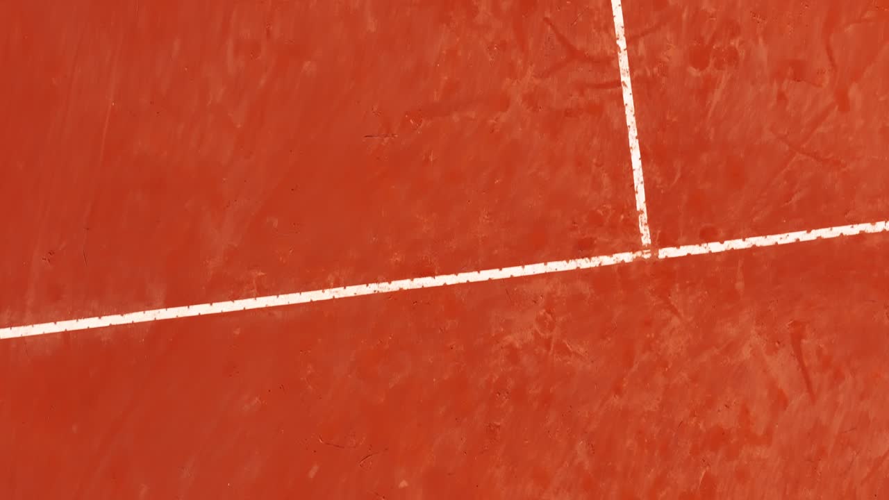 Bird’s-eye drone scanning across the full tennis clay court in Italy, Italia, capturing a bright summer sports atmosphere