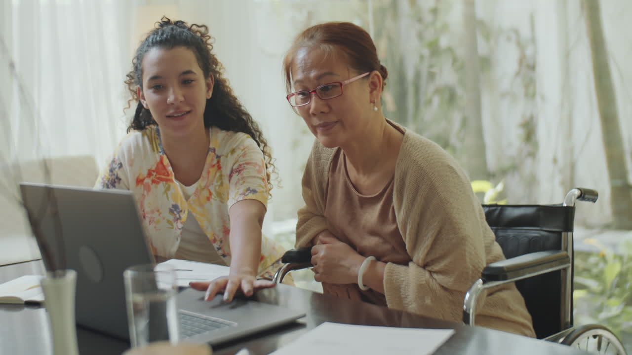 Two women working on a laptop together