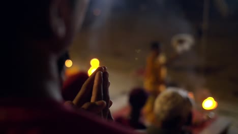 man praying at nighttime ceremony