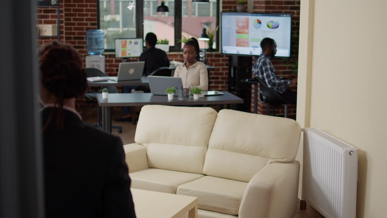 Female manager looking at sales report on laptop computer