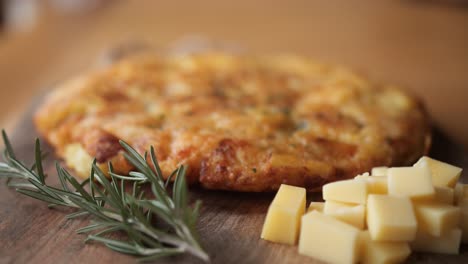 defocus shot of frika, slovenian dish from tolmin, rosemary and cheese in foreground