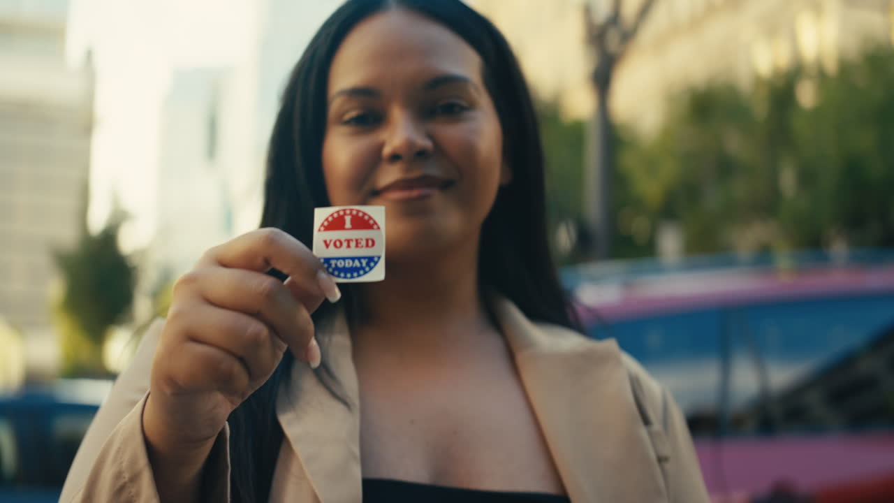 Woman showing I Voted sticker