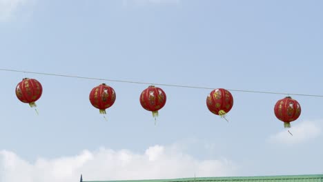 colorful red lanterns sway in the breeze enhancing the festive atmosphere of a cultural celebration.