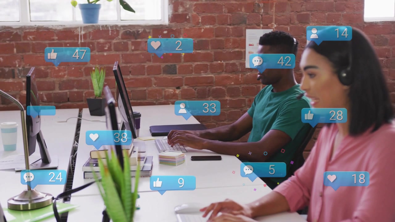 Notifications rising around monitors, pair responding typing and speaking, managing social media
