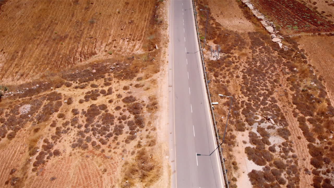 Flying over empty desert road