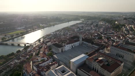 aerial forward over coimbra university and mondego river in background, portugal