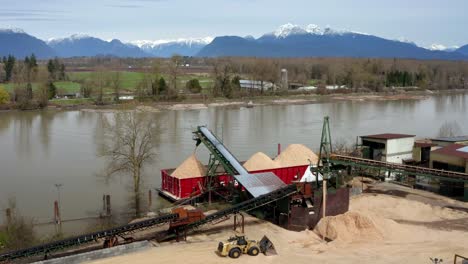 aerial view of sand loading barge at fraser river in port kells, surrey, canada - drone shot