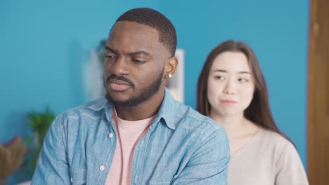 african man angry and offended at his asian girlfriend.