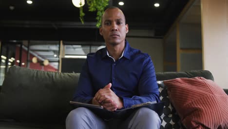 Mixed-race-businessman-having-video-chat-listening-and-nodding-in-office