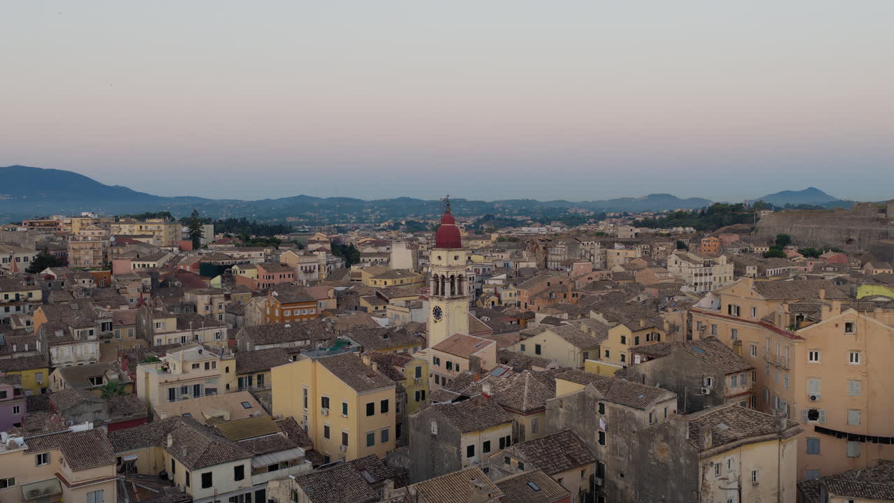 Slow orbit drone video of Saint Spyridon Church in Corfu old town at sunrise